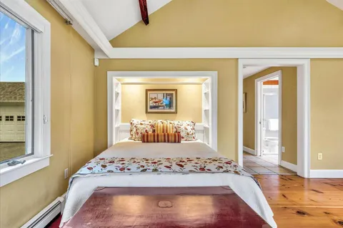 a bathroom with a granite countertop sink and a window