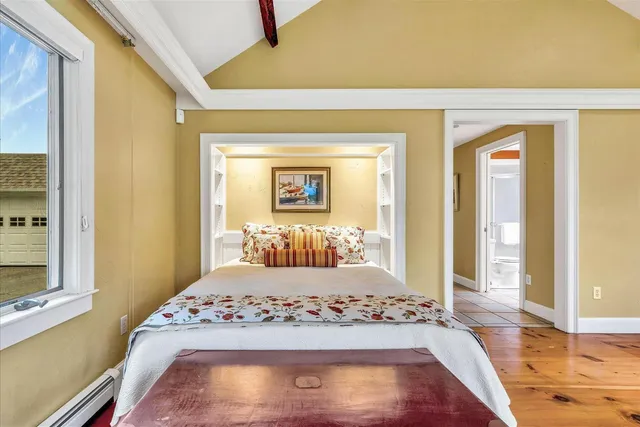 a bathroom with a granite countertop sink and a window