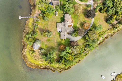 a front view of a house with yard patio and green space