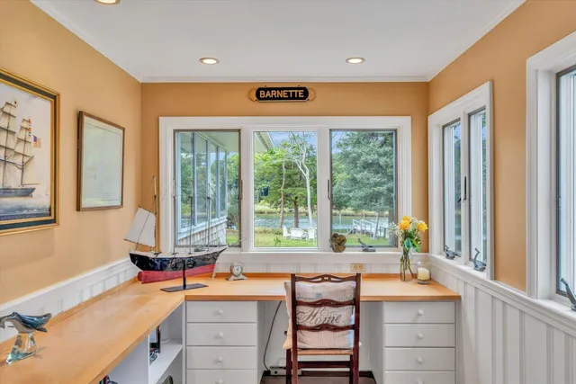 a living room with furniture a rug and a large window