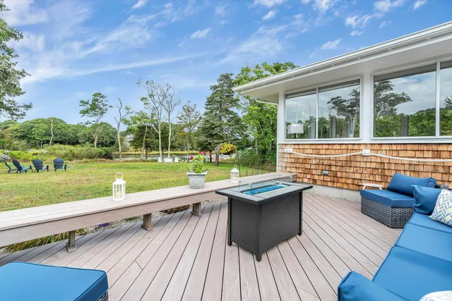 a view of a patio with couches table and chairs and potted plants