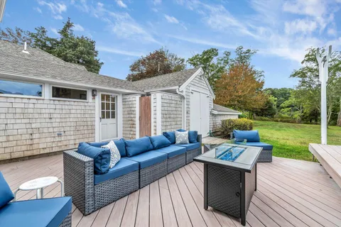 a balcony with furniture and a large window