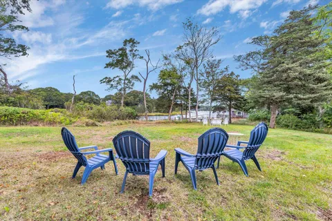 an aerial view of residential houses with outdoor space and lake view