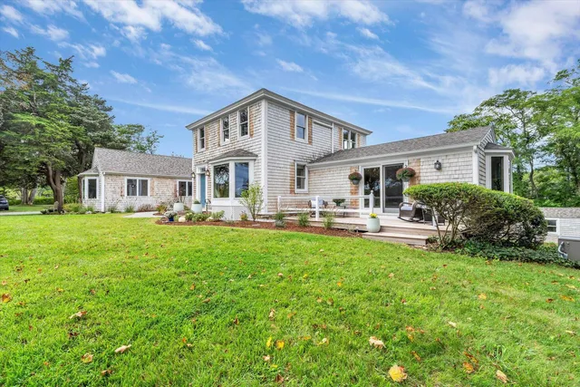 a view of a house with chairs and potted plant