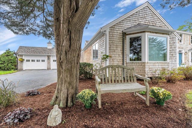 a view of a living room with a large window and bed