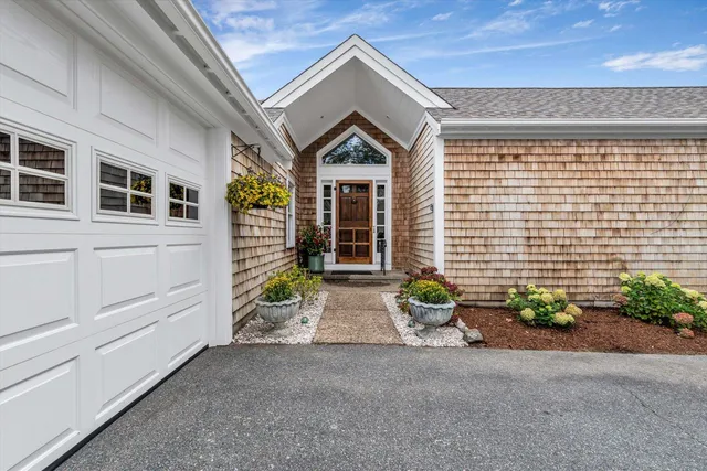 a bedroom with a bed and a large mirror on the dresser