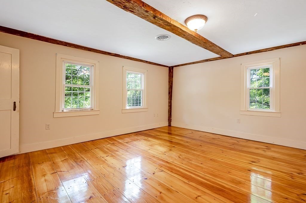 67 Stone School Road Sutton, MA 01590 - Photo 17 of 41 a view of an empty room with wooden floor and a window