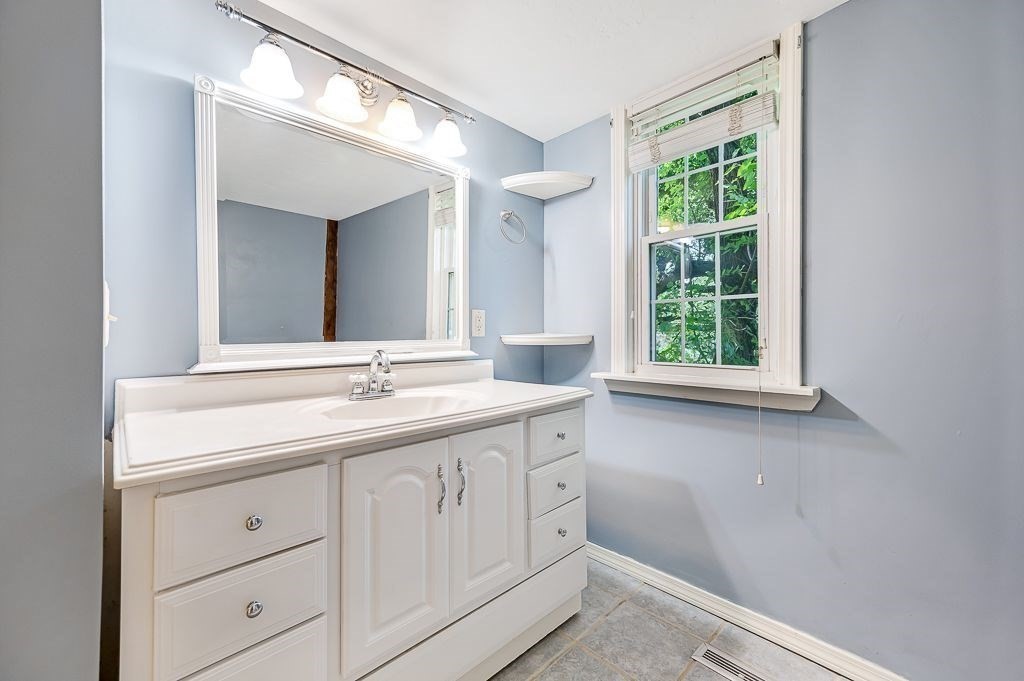 67 Stone School Road Sutton, MA 01590 - Photo 19 of 41 a bathroom with a double vanity sink and a window