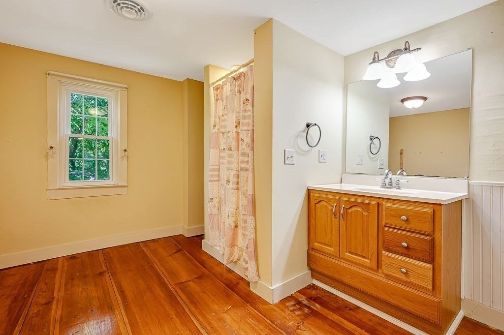 67 Stone School Road Sutton, MA 01590 - Photo 23 of 41 a spacious bathroom with a double vanity sink a mirror and a shower