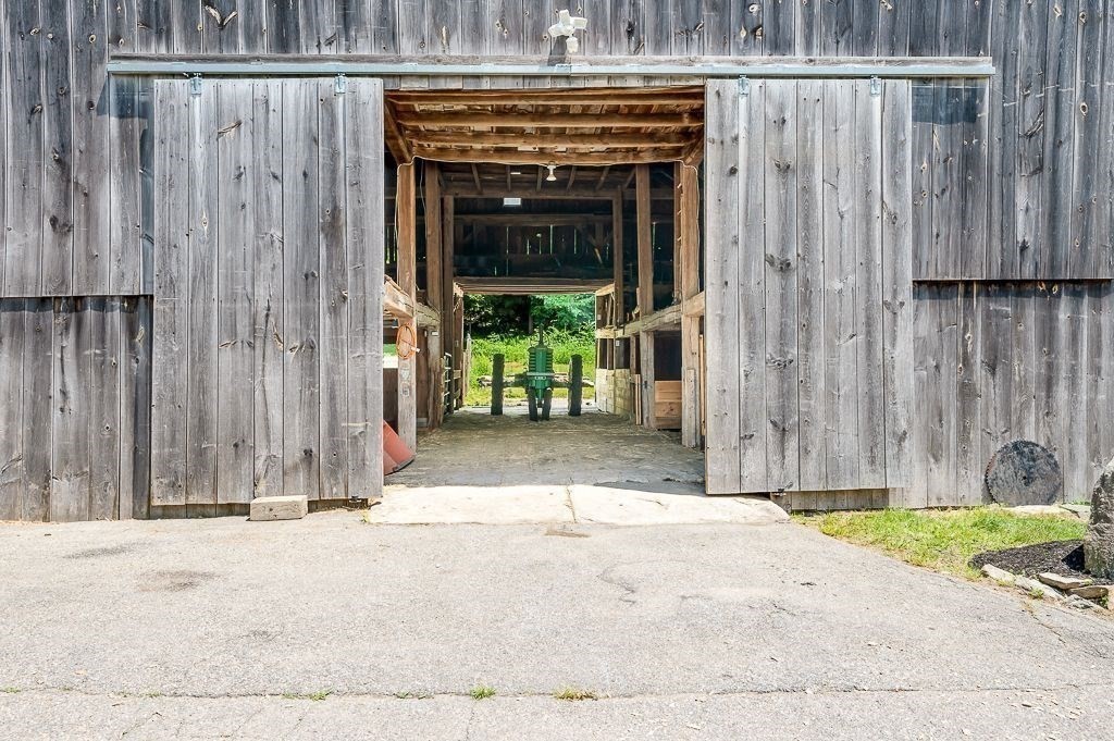 67 Stone School Road Sutton, MA 01590 - Photo 3 of 41 a view of a entrance gate of a building with grass