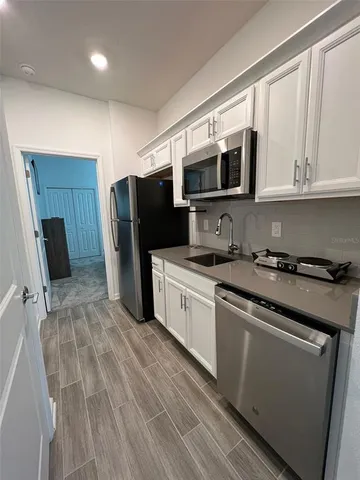 a kitchen with stainless steel appliances a refrigerator stove microwave and sink