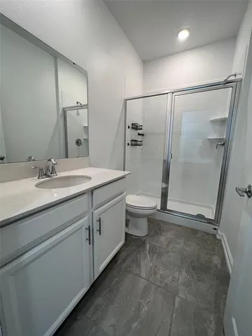 a bathroom with a double vanity sink toilet and shower