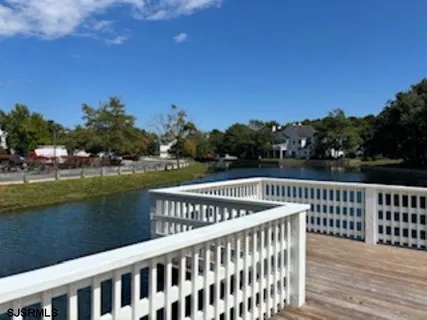 a view of balcony with wooden floor and lake view