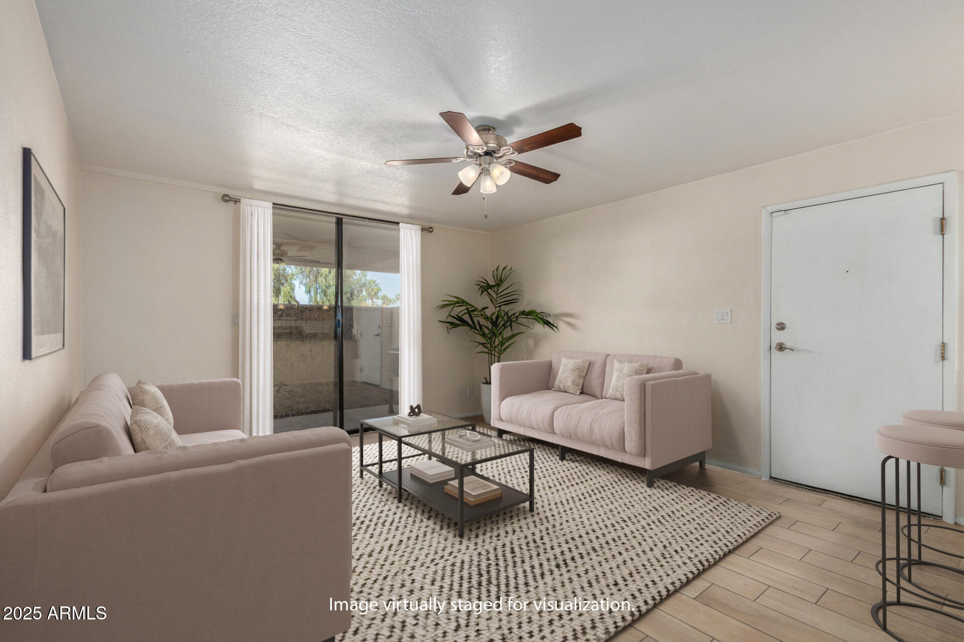 1125 East Broadway Road, Unit 102 Tempe, AZ 85282 - Photo 3 of 10 a living room with furniture and a rug