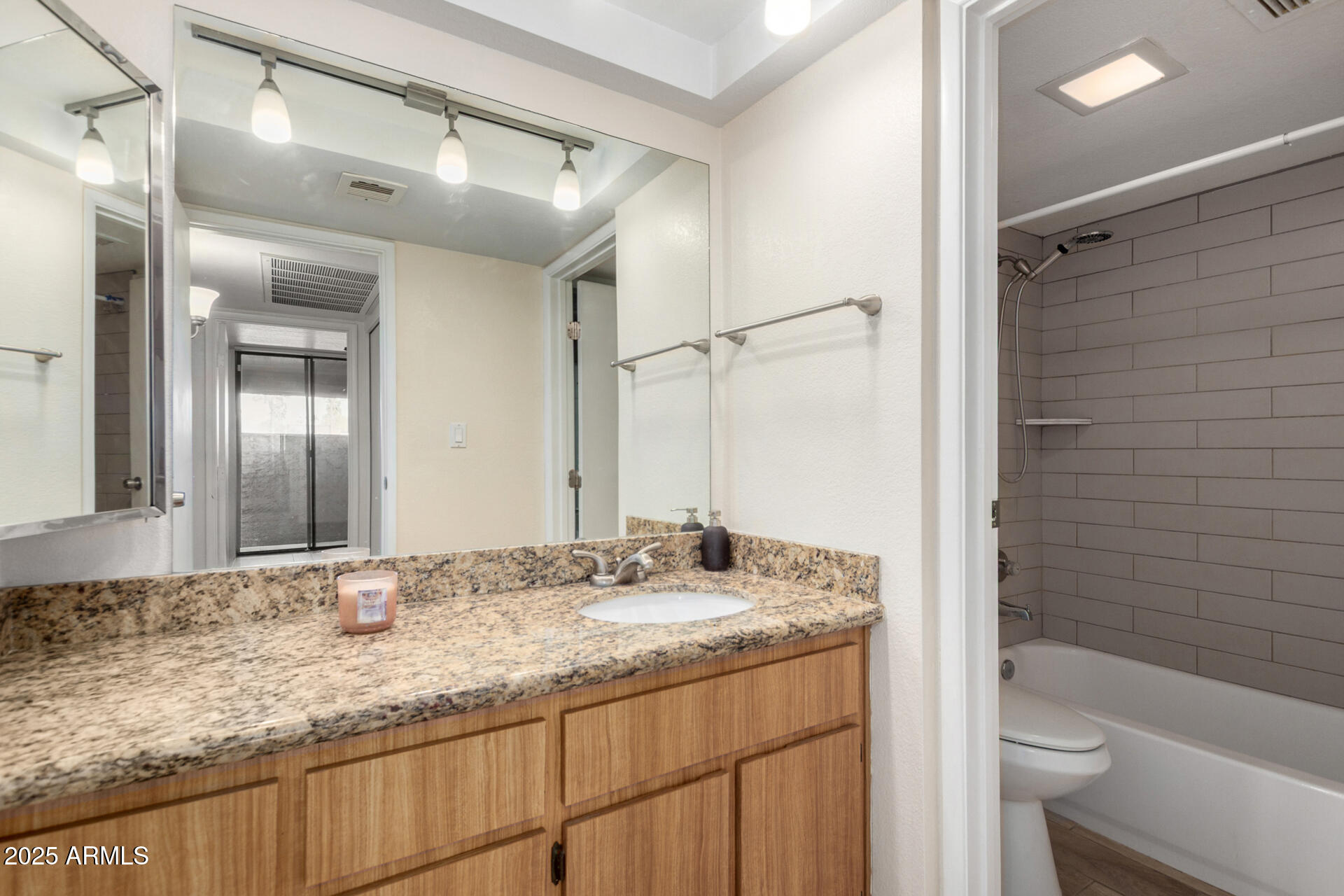 1125 East Broadway Road, Unit 102 Tempe, AZ 85282 - Photo 8 of 10 a bathroom with a granite countertop sink toilet and shower