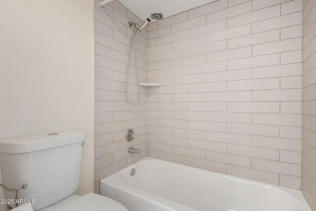 a bathroom with a bathtub and a toilet