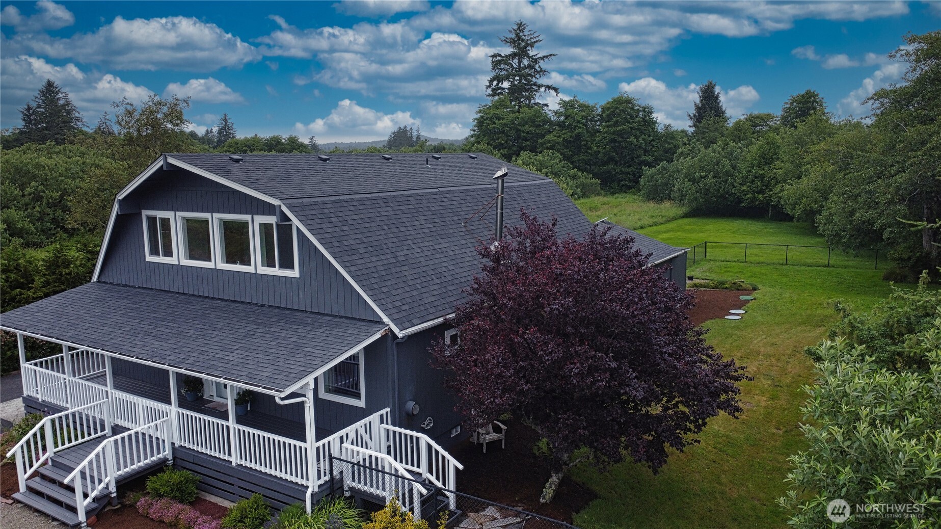 240 Stringtown Road Ilwaco, WA 98624 - Photo 34 of 39 a aerial view of a house with a yard and garage
