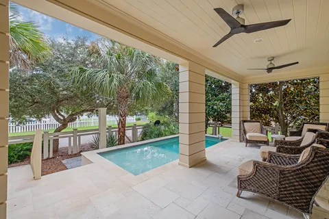 a bedroom with a bed potted plant on dresser and a chandelier