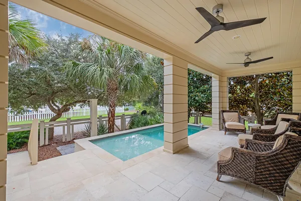 a bedroom with a bed potted plant on dresser and a chandelier