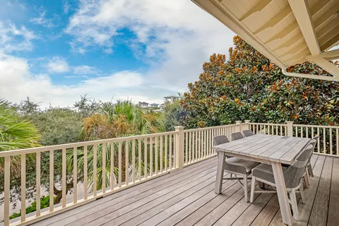 a view of a city from a roof deck with furniture