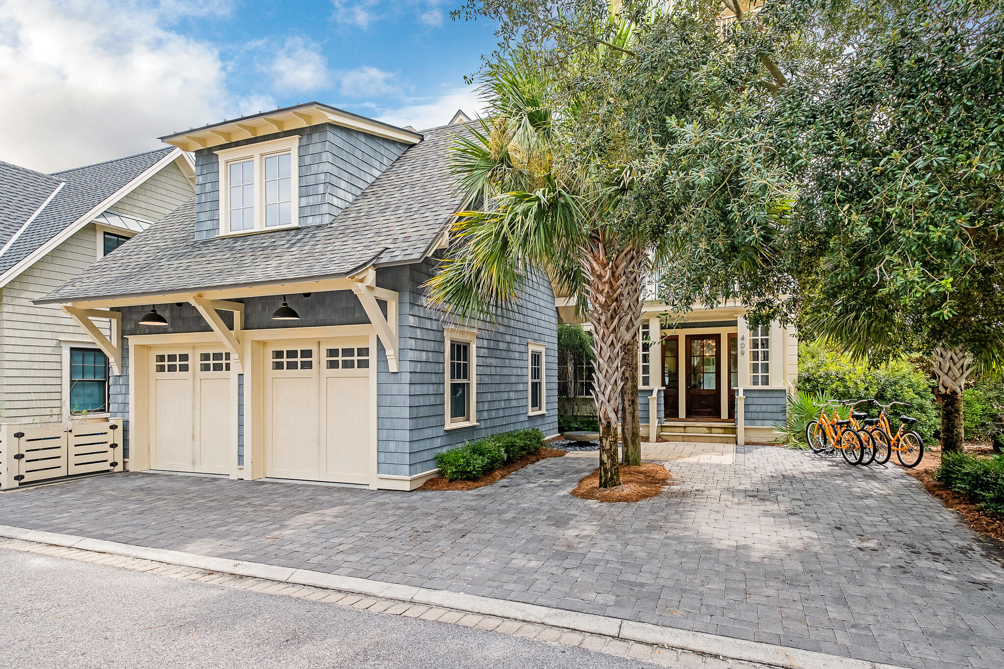 409 Coopersmith Lane Inlet Beach, FL 32461 - Photo 4 of 97 a front view of a house with garden and garage