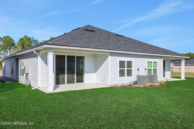 a front view of house with yard and porch with seating