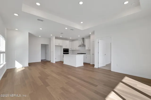 a view of kitchen with refrigerator and window