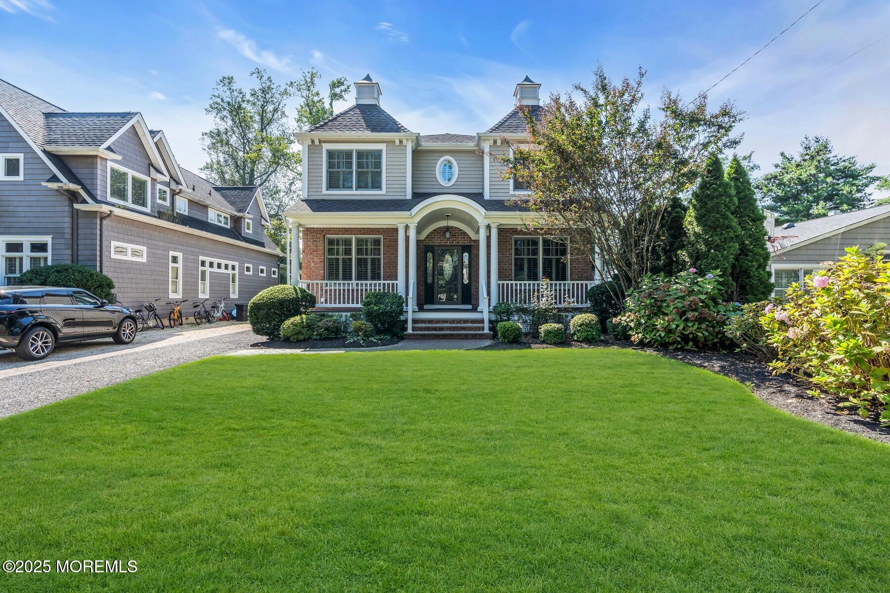 12 Forrest Avenue Rumson, NJ 07760 - Photo 20 of 55 a front view of a house with a garden