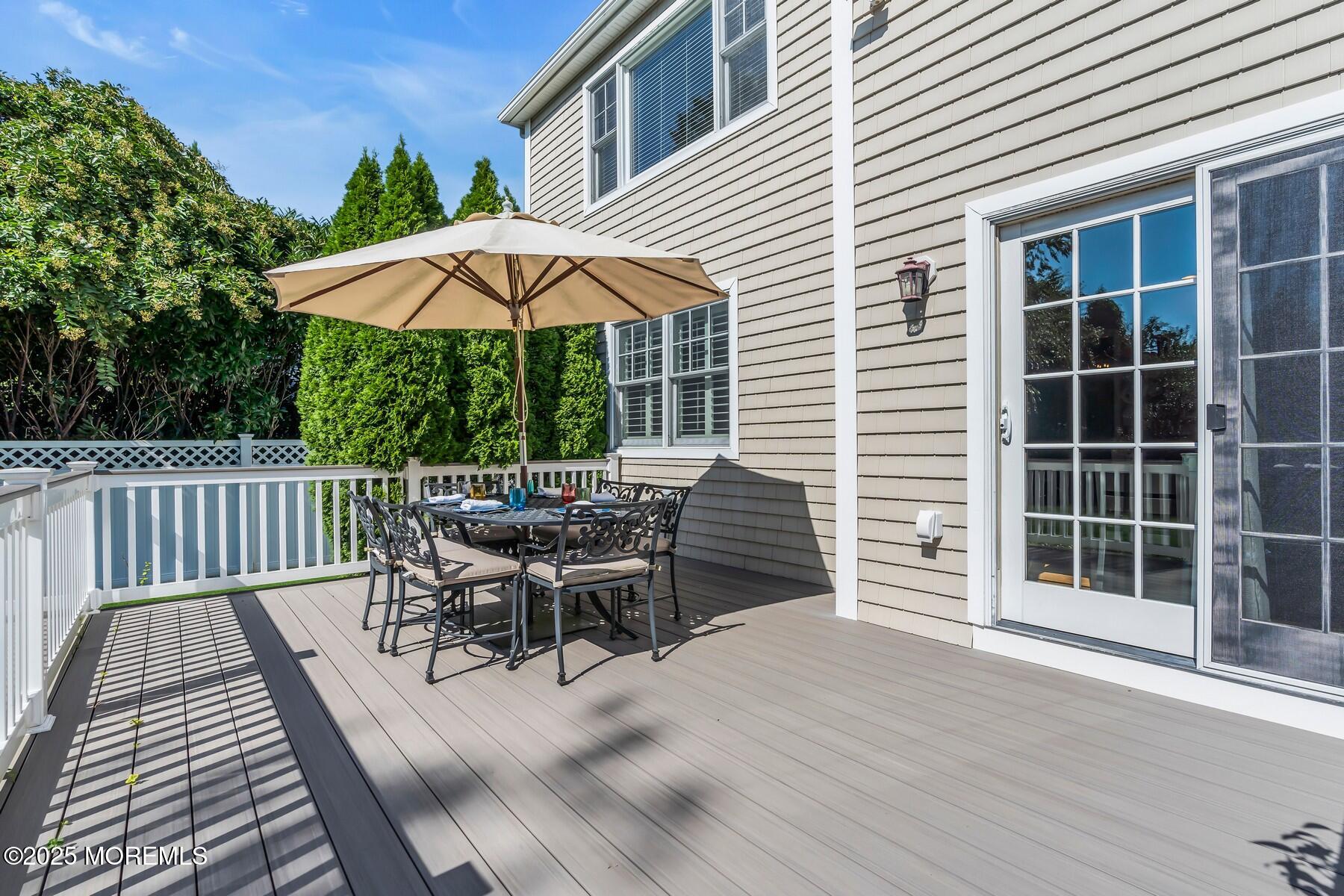 12 Forrest Avenue Rumson, NJ 07760 - Photo 28 of 55 a view of a roof deck with table and chairs under an umbrella