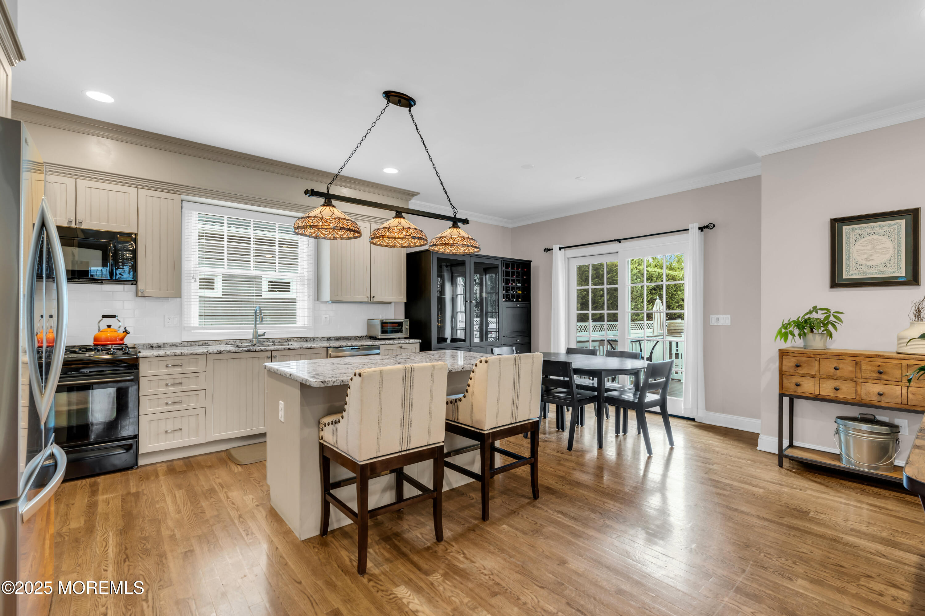 12 Forrest Avenue Rumson, NJ 07760 - Photo 46 of 55 a dining room with wooden floor a chandelier a wooden table and chairs