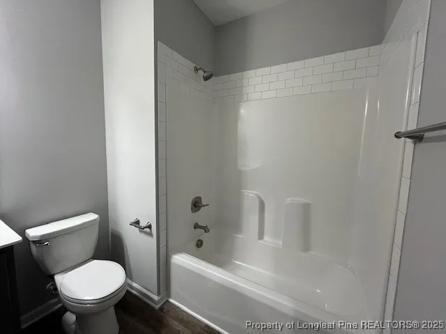 a white toilet sitting next to a bath tub
