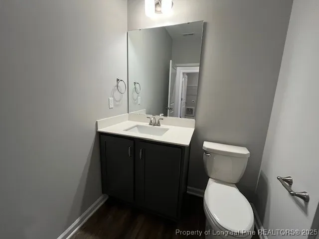 a bathroom with a sink toilet and mirror