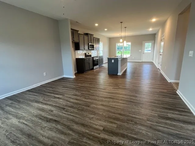 a view of kitchen and dining room with wooden floor
