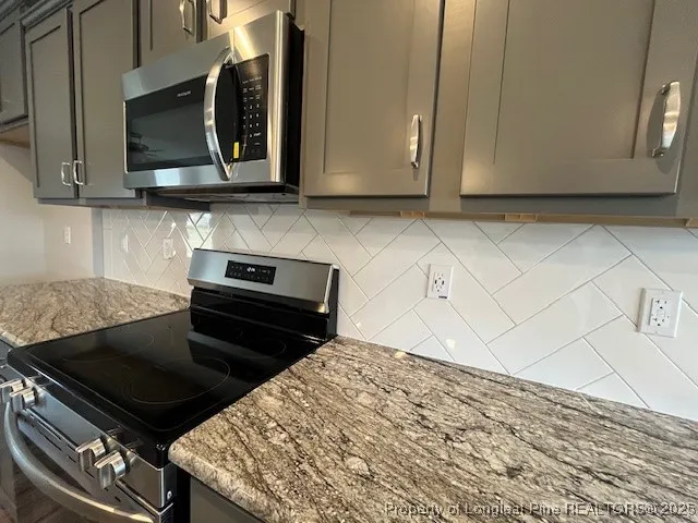a kitchen with a stove and a microwave