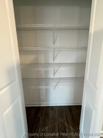 a view of walk in closet with empty racks
