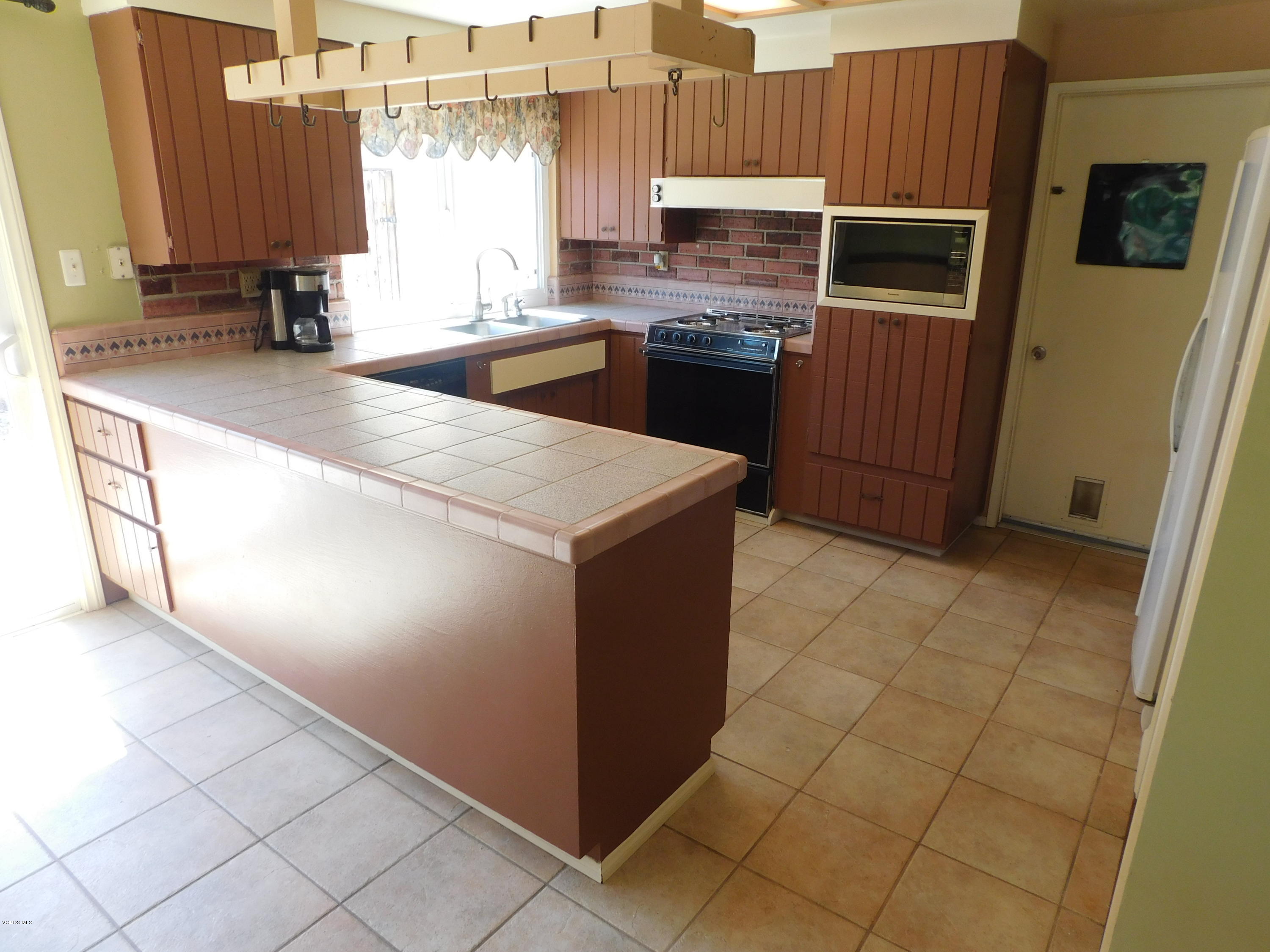 2105 Rhoda Street Simi Valley, CA 93065 - Photo 3 of 15 a kitchen with stainless steel appliances a stove a sink a microwave and a refrigerator