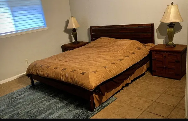 a bed sitting in a bedroom next to a window