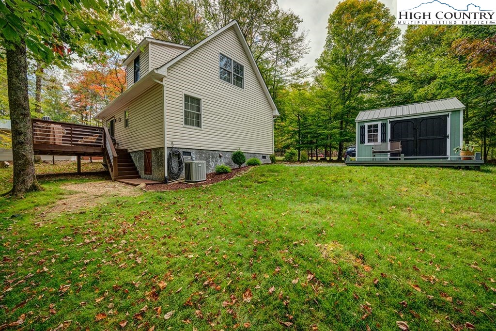 607 Charter Hills Road Beech Mountain, NC 28604 - Photo 27 of 31 a view of a house with a yard