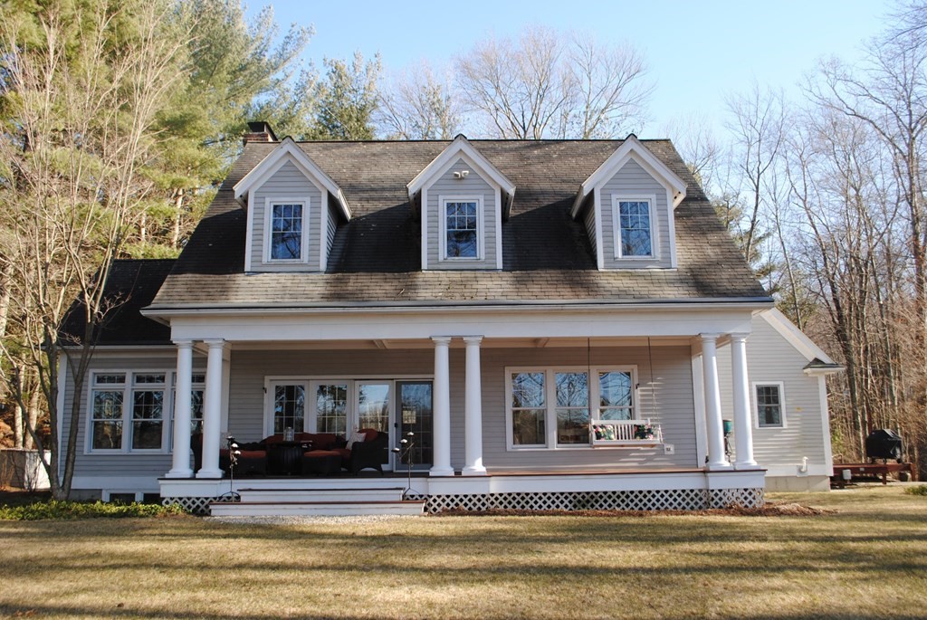 518 Douglas Road Northbridge, MA 01588 - Photo 2 of 41 a view of a white house with large windows and a table and chairs in front of it