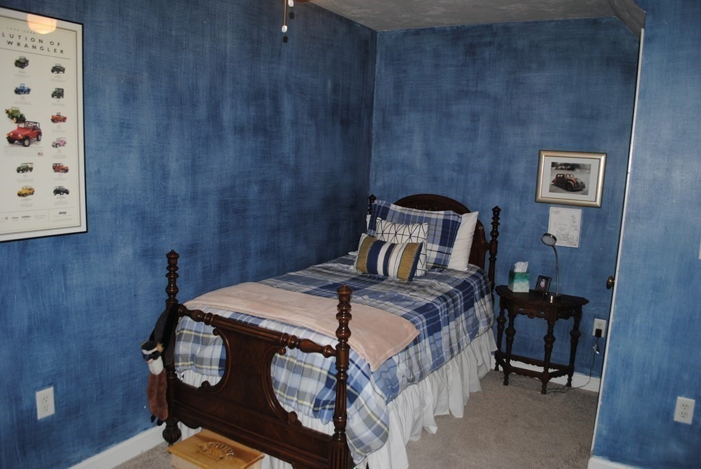 518 Douglas Road Northbridge, MA 01588 - Photo 21 of 41 a bed sitting in a bedroom next to a small cabinet