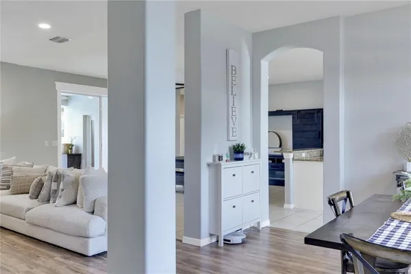 a living room with furniture and wooden floor
