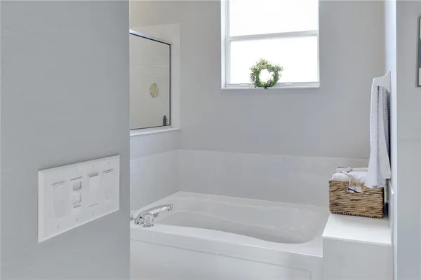 a bathroom with a bathtub and a window