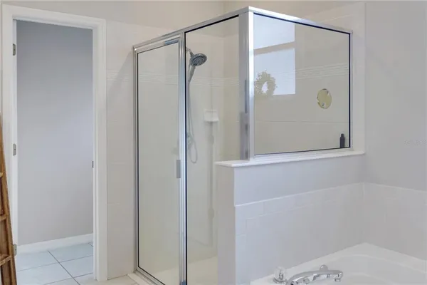 a bathroom with a shower and a glass door