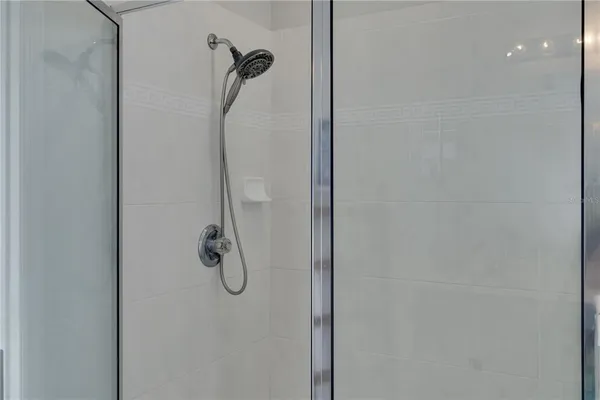 a bathroom with a glass shower door