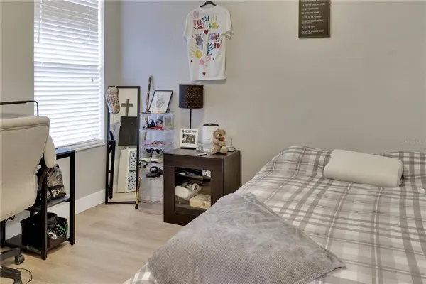 a bedroom with a bed and a desk