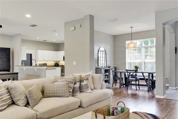 a living room with furniture dining area and a large window