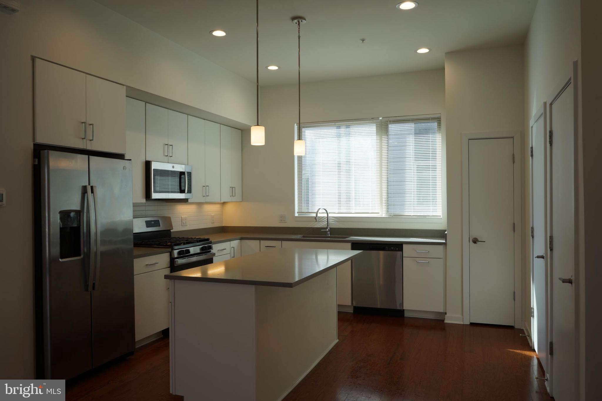 3130 Pierview Lane Philadelphia, PA 19125 - Photo 4 of 26 a kitchen with stainless steel appliances granite countertop a sink a refrigerator and a granite counter tops