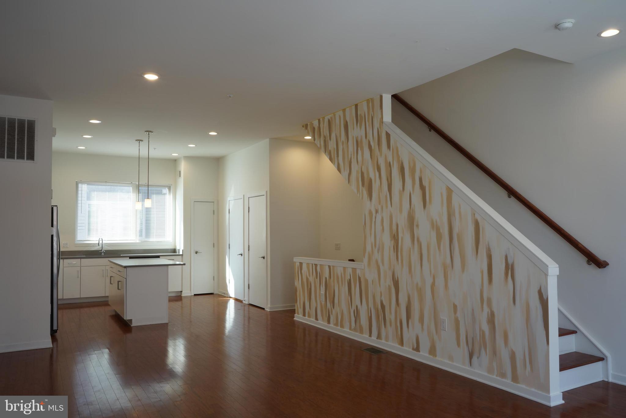 3130 Pierview Lane Philadelphia, PA 19125 - Photo 10 of 26 a view of a kitchen with a white kitchen center island wooden floor and stainless steel appliances