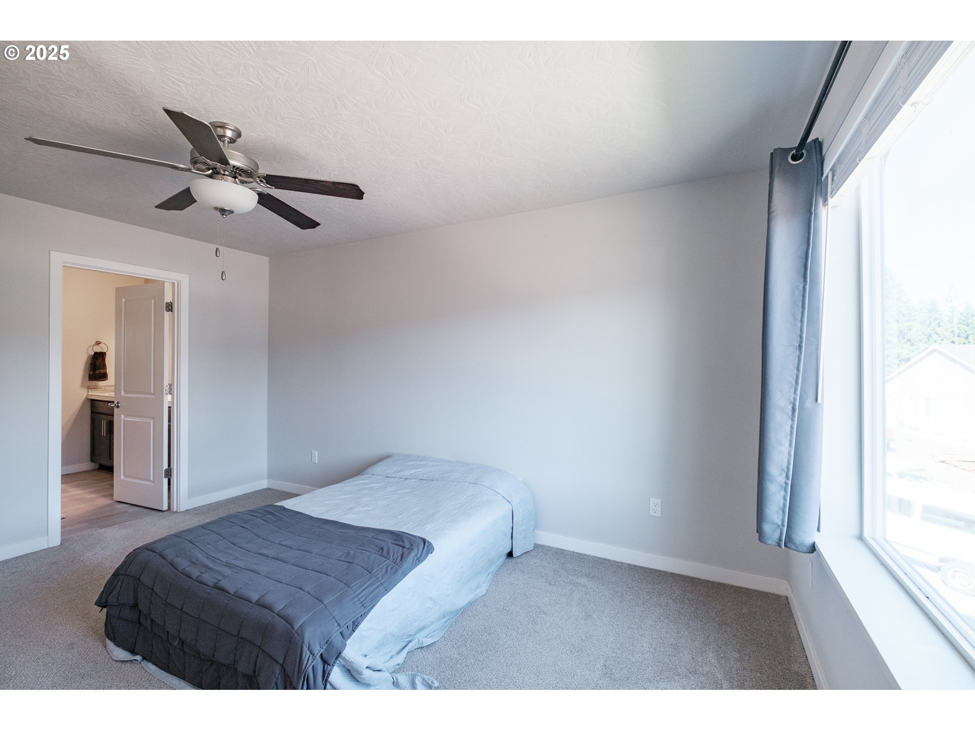 4465 Ninebark Loop Sweet Home, OR 97386 - Photo 13 of 23 a bedroom with a bed chandelier and a window
