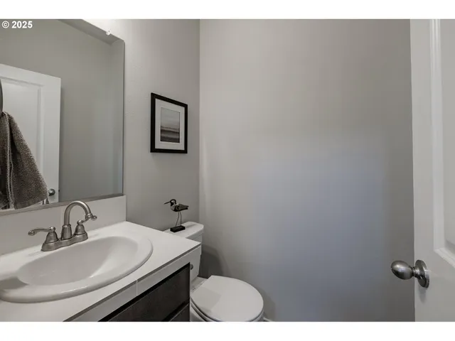 a bathroom with a sink mirror and toilet